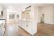 Spacious kitchen with white cabinets, large island, and modern lighting fixtures at 2505 Showcase Dr, Las Vegas, NV 89134