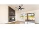 Modern living room with fireplace, ceiling fan, and large sliding doors at 2505 Showcase Dr, Las Vegas, NV 89134