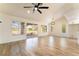 Bright living room features wood-look floors, ceiling fan, and sliding glass doors to the outside at 2505 Showcase Dr, Las Vegas, NV 89134