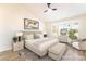 Inviting main bedroom with wood floors, a ceiling fan, and a cozy sitting area at 2505 Showcase Dr, Las Vegas, NV 89134