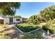 Back yard featuring mature shade trees, garden area, and house exterior at 2600 E Owens Ave, North Las Vegas, NV 89030
