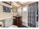 Bathroom featuring modern fixtures, a dark wood vanity, and stylish shower curtain at 2600 E Owens Ave, North Las Vegas, NV 89030