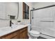 Bathroom features a walk-in shower, tile surround, wood-look vanity and modern fixtures at 2601 Gallarate Dr, Henderson, NV 89044