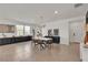 Contemporary dining room with modern table, striking light fixture, and abundant natural light at 2601 Gallarate Dr, Henderson, NV 89044
