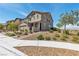 Attractive two-story home with a well-maintained front yard, showcasing a blend of stone and landscaping elements at 2601 Gallarate Dr, Henderson, NV 89044