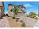 Charming two-story home with landscaped front yard and a brick-paved driveway, creating a welcoming curb appeal at 2601 Gallarate Dr, Henderson, NV 89044