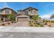 Inviting two-story home featuring a charming front yard with manicured landscaping and a brick-paved driveway at 2601 Gallarate Dr, Henderson, NV 89044