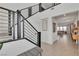 Bright foyer showcasing modern staircase with black railings and views into the open-concept living spaces at 2601 Gallarate Dr, Henderson, NV 89044