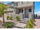 Inviting front porch with stone steps and wrought iron gate leading to a cozy entrance with well-maintained landscaping at 2601 Gallarate Dr, Henderson, NV 89044