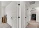 Bright hallway with paneled doors leading to a laundry room and other rooms at 2601 Gallarate Dr, Henderson, NV 89044