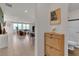 Open hallway leading to a living area and bathroom, with tile flooring and a decorative cabinet at 2601 Gallarate Dr, Henderson, NV 89044