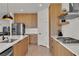 Modern kitchen features wooden cabinets, stainless steel appliances, and white countertops at 2601 Gallarate Dr, Henderson, NV 89044