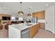 Open concept kitchen with island, stainless steel appliances, and hardwood floor at 2601 Gallarate Dr, Henderson, NV 89044