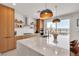 Bright kitchen with an island, wooden cabinets and modern appliances at 2601 Gallarate Dr, Henderson, NV 89044