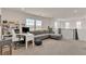 Bright living area with large gray sectional sofa, workspace, and view from the spacious loft at 2601 Gallarate Dr, Henderson, NV 89044