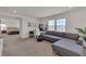 Open living area features a comfortable gray sofa, bright windows, and work space with a view at 2601 Gallarate Dr, Henderson, NV 89044