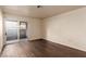 Well-lit bedroom featuring hardwood floors and sliding doors opening to a private patio or balcony at 2606 Durango Dr # 181, Las Vegas, NV 89117