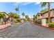 Wide view of the community entrance with mature landscaping and well-maintained road at 2606 Durango Dr # 181, Las Vegas, NV 89117