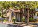 Two-story condo building showcasing stucco architecture, a tile roof, trimmed greenery, arched doorway and second story staircase at 2606 Durango Dr # 181, Las Vegas, NV 89117