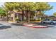 Condo complex with covered parking, mature trees, and well maintained landscaping, including gate, curbs and trees at 2606 Durango Dr # 181, Las Vegas, NV 89117