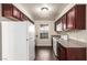 Kitchen features updated cherry cabinets and white appliances at 2606 Durango Dr # 181, Las Vegas, NV 89117