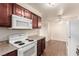 Kitchen features cherry cabinets and modern appliances at 2606 Durango Dr # 181, Las Vegas, NV 89117