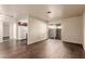 Spacious living room with hardwood floors, sliding glass doors to a patio, and a view into the kitchen at 2606 Durango Dr # 181, Las Vegas, NV 89117