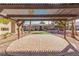 Lovely paved outdoor patio area with a pergola overlooking the community putting green at 2606 Durango Dr # 181, Las Vegas, NV 89117