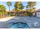 Community pool area featuring palm trees and lounge seating, perfect for relaxation in a comfortable setting at 2606 Durango Dr # 181, Las Vegas, NV 89117