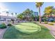 Putting green, perfect for practice, is set amidst desert landscaping and mature palm trees at 2606 Durango Dr # 181, Las Vegas, NV 89117