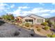 View of the backyard featuring a covered patio and terraced landscaping at 2651 Solera Moon Dr, Henderson, NV 89044