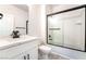 Bright bathroom with white cabinets, quartz countertops and shower with black trim at 2651 Solera Moon Dr, Henderson, NV 89044