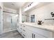 Bathroom featuring double vanity, marble countertops, glass enclosed shower and modern fixtures at 2651 Solera Moon Dr, Henderson, NV 89044