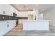 Modern kitchen with white cabinets, gray backsplash, stainless steel appliances, and a center island at 2651 Solera Moon Dr, Henderson, NV 89044