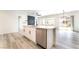 Modern open kitchen with a center island, stainless steel appliances, and sliding glass doors to the backyard at 2651 Solera Moon Dr, Henderson, NV 89044