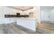 Well-appointed kitchen with a center island, white cabinets, stainless appliances, and a seamless flow to other living spaces at 2651 Solera Moon Dr, Henderson, NV 89044
