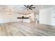 Expansive open-concept layout showcasing the living room, kitchen, and dining area with elegant light wood flooring at 2651 Solera Moon Dr, Henderson, NV 89044