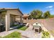 Backyard features paver patio with dining and lounge seating, desert landscaping, and privacy wall at 2780 Gallant Hills Dr, Las Vegas, NV 89135