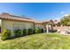 Backyard features well-manicured landscaping, patio with seating and a grill, and solar panels on roof at 2780 Gallant Hills Dr, Las Vegas, NV 89135