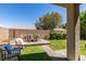 Fully landscaped backyard has desert landscaping, patio seating, and artificial turf at 2780 Gallant Hills Dr, Las Vegas, NV 89135