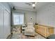 Charming Bedroom with stylish wallpaper, a cozy crib, and a comfortable reading chair at 2780 Gallant Hills Dr, Las Vegas, NV 89135