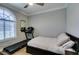 Cozy bedroom with ample natural light featuring a treadmill for in-home workouts at 2780 Gallant Hills Dr, Las Vegas, NV 89135