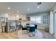 Bright dining area with glass table, teal chairs, and white kitchen with stainless steel appliances at 2780 Gallant Hills Dr, Las Vegas, NV 89135