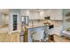 Bright kitchen featuring white cabinets, stainless steel appliances, and a breakfast bar with seating at 2780 Gallant Hills Dr, Las Vegas, NV 89135