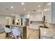 Modern kitchen with white cabinets, stainless steel appliances, a breakfast bar, and wood-look flooring at 2780 Gallant Hills Dr, Las Vegas, NV 89135