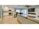 Open-concept living area featuring modern fireplace, tv and comfortable seating flowing into a stylish kitchen and dining space at 2780 Gallant Hills Dr, Las Vegas, NV 89135