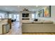 Bright living room featuring recessed lighting, modern artwork, and a sleek fireplace, enhancing the home's contemporary aesthetic at 2780 Gallant Hills Dr, Las Vegas, NV 89135