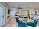 Open-concept living room and dining area featuring modern decor, a glass table, and a comfortable sectional sofa at 2780 Gallant Hills Dr, Las Vegas, NV 89135