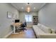 Bright home office boasts modern desk, shelving unit, and sofa beneath a stylish, decorative light fixture at 2780 Gallant Hills Dr, Las Vegas, NV 89135