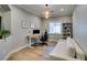 Bright home office boasts modern desk, shelving unit, and sofa beneath a stylish, decorative light fixture at 2780 Gallant Hills Dr, Las Vegas, NV 89135